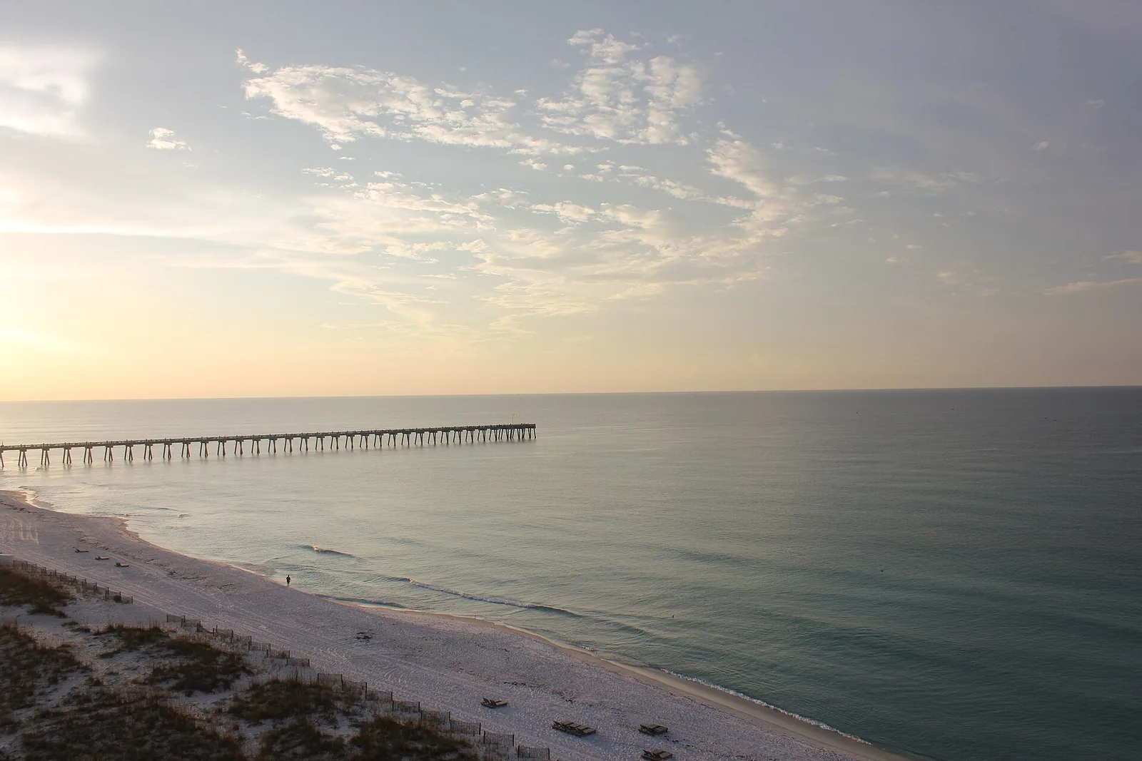 The Gulf shore and pier at Pensacola Beach, where the island's two dog beaches sit at the west and east ends.