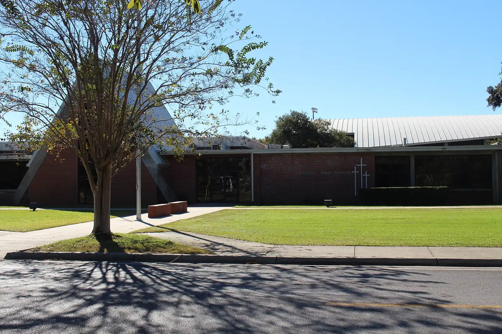 Catholic High School in Pensacola, with stadium light poles behind the main building.