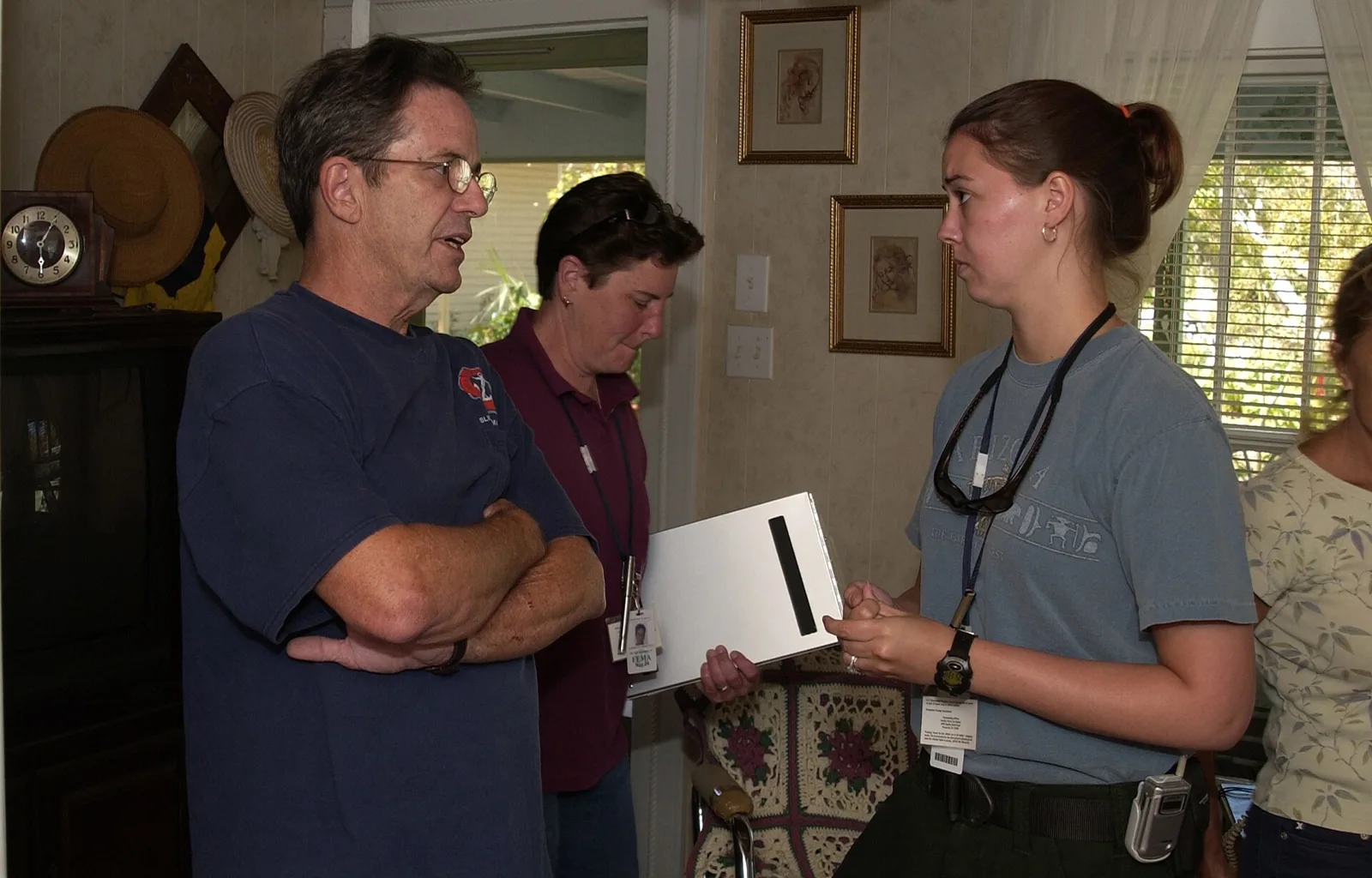 A FEMA housing inspector talks with a Pensacola homeowner about tree damage after Hurricane Ivan. The picture does not show Hurricane Isaias.