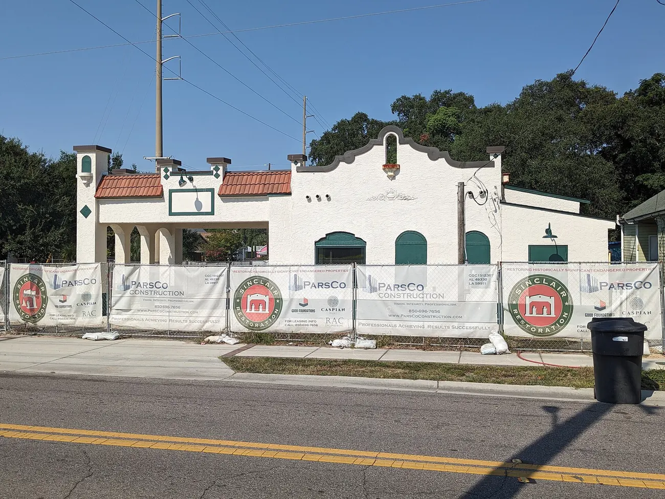The Motor Inn Number 2, a building listed on the National Register of Historic Places, behind construction fencing in Pensacola's Belmont-DeVilliers area.