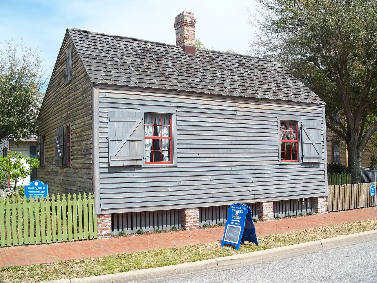 Julee Cottage, a wooden house with red shutters in the Pensacola Historic District.