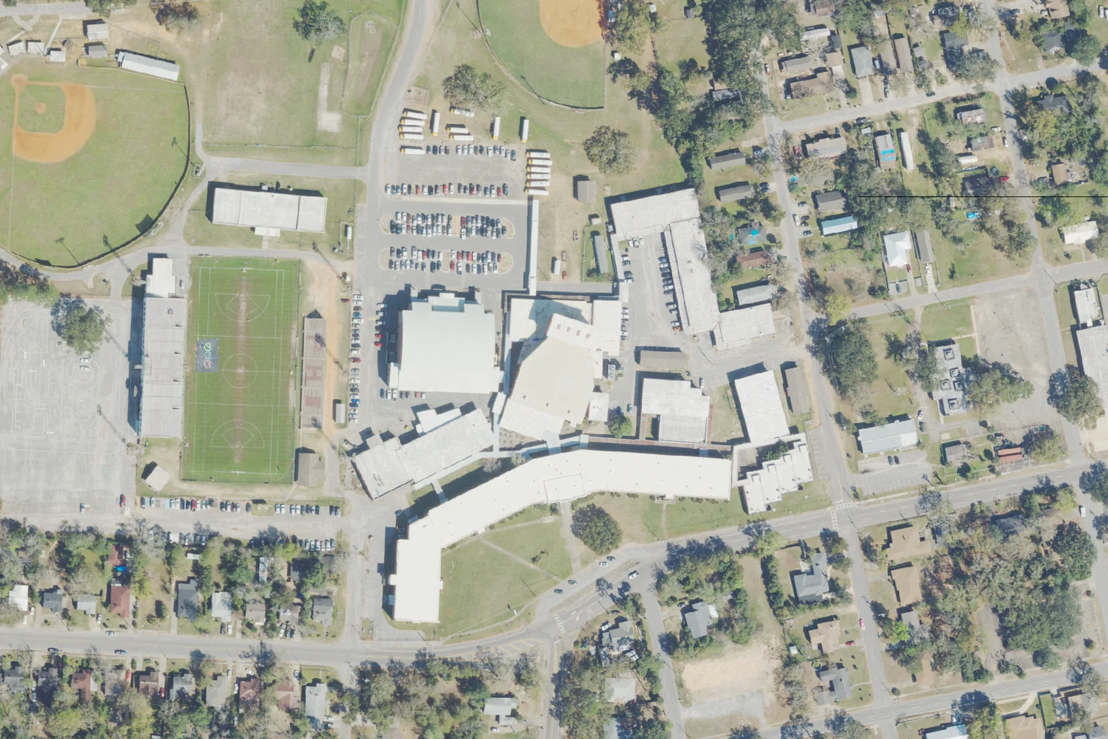 Pensacola High School's campus north of downtown, with its stadium, ball fields and bus lot, seen from the air.