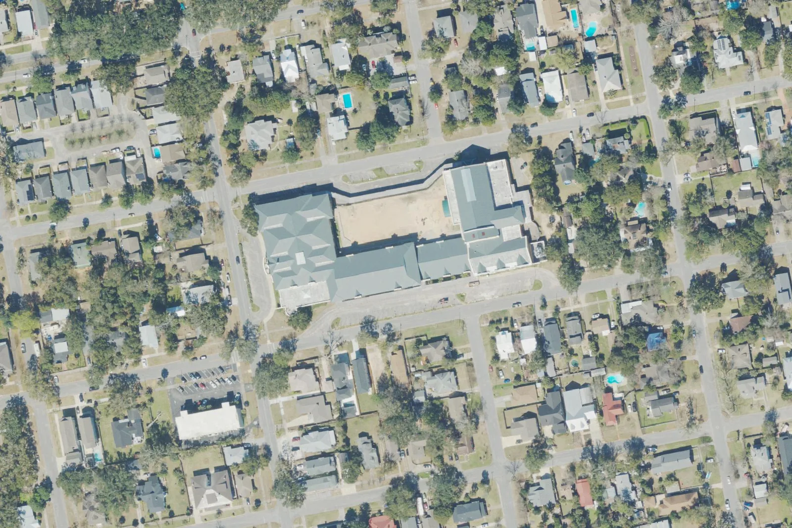N.B. Cook Elementary School's gray-roofed building among the houses off North 12th Avenue in Pensacola, seen from the air.