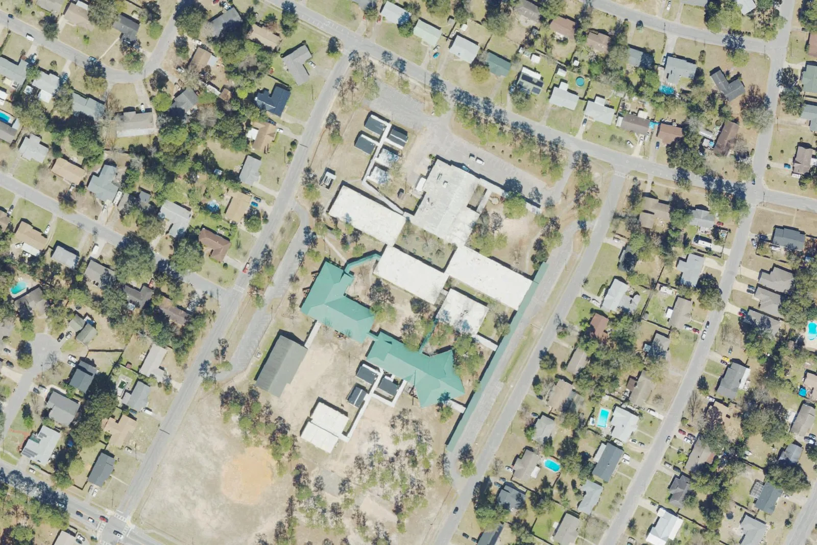 Scenic Heights Elementary School's green-roofed buildings and playground off Cherry Laurel Drive in northeast Pensacola, seen from the air.
