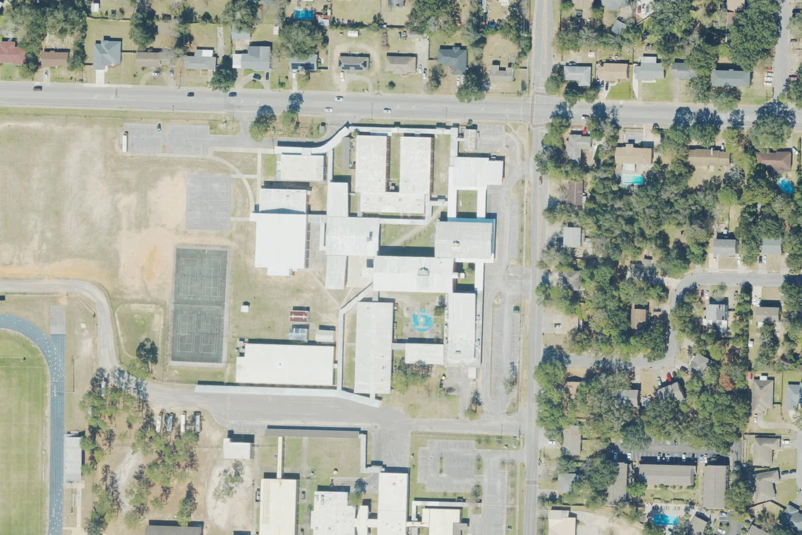 J.H. Workman Middle School's campus on Lanier Drive in north Pensacola, with its courts and fields beside the classroom wings, seen from the air.