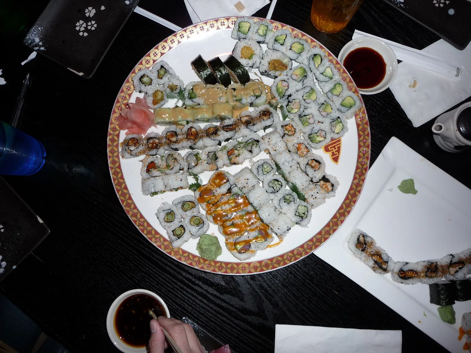 A platter of assorted sushi rolls with soy sauce and wasabi, photographed outside Pensacola and not at a place on this list.