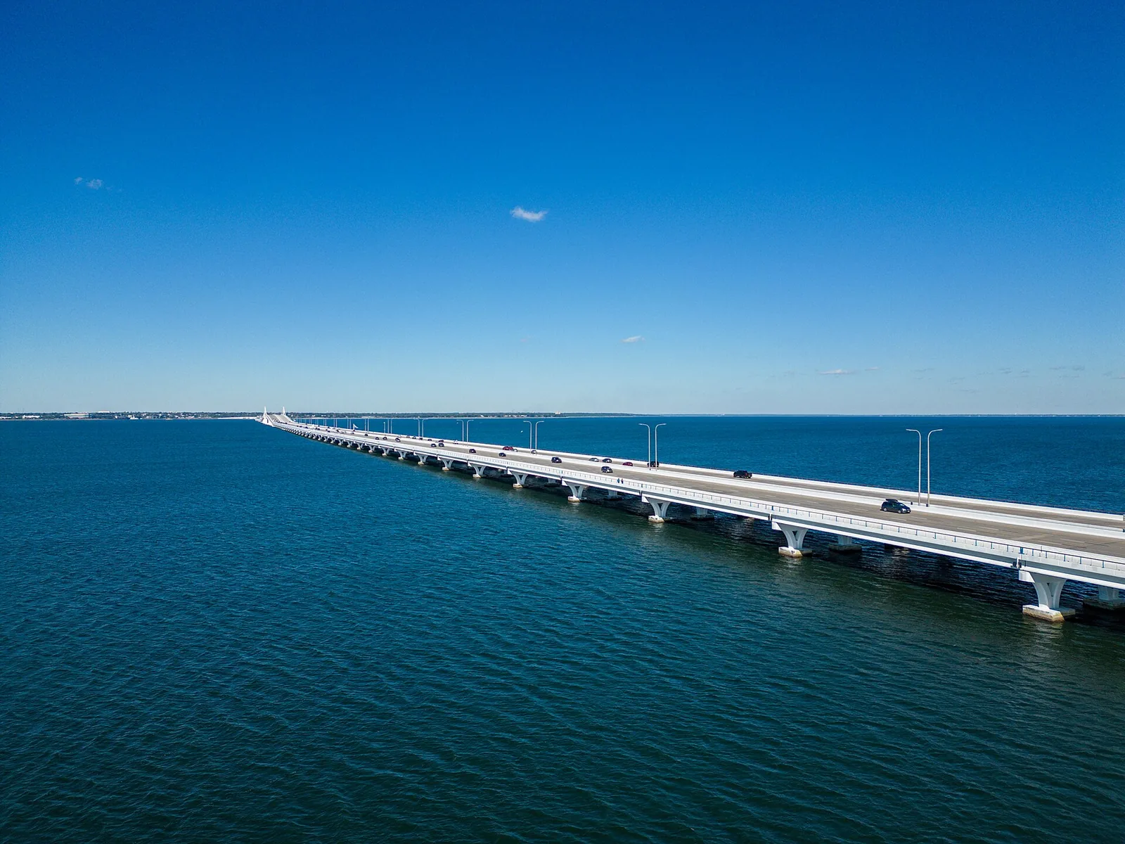 The Pensacola Bay Bridge crossing the bay toward Gulf Breeze, with its barrier-separated multi-use path along the side.