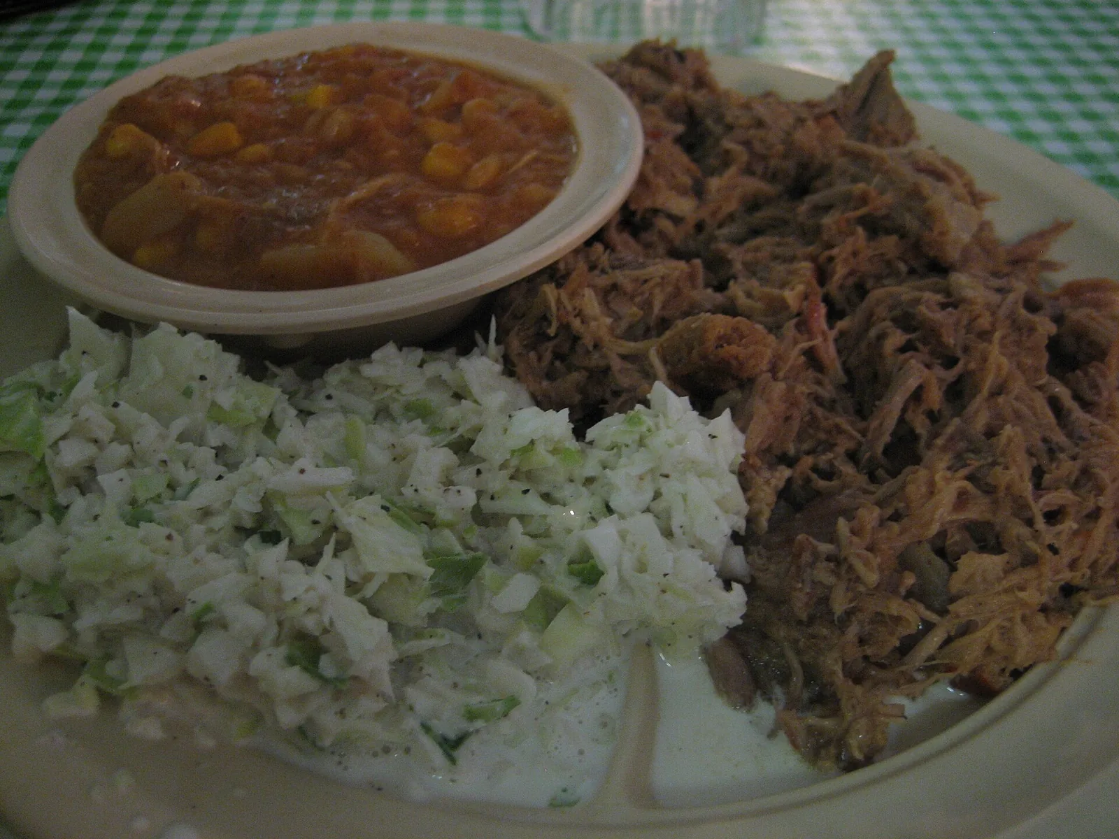 A barbecue plate of pulled pork, coleslaw and Brunswick stew, photographed outside Pensacola and not at a place on this list.