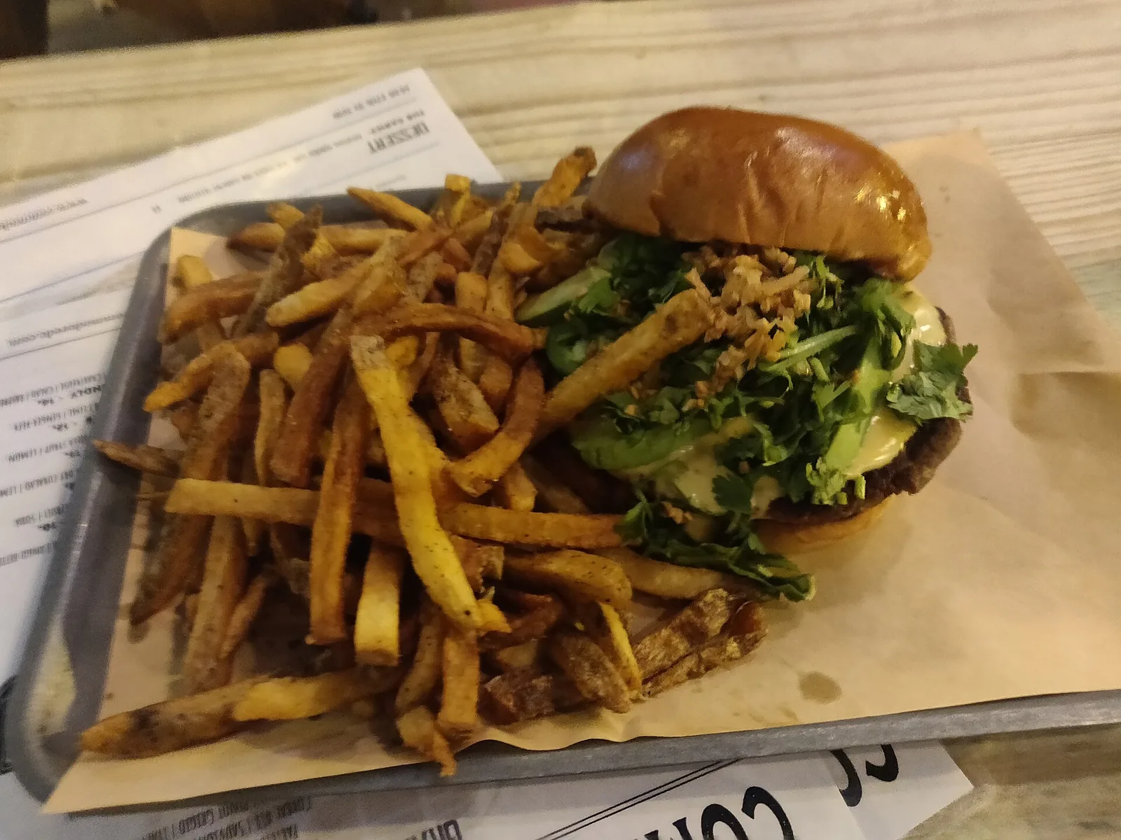 A cheeseburger and fries on a tray, photographed outside Pensacola and not at a place on this list.